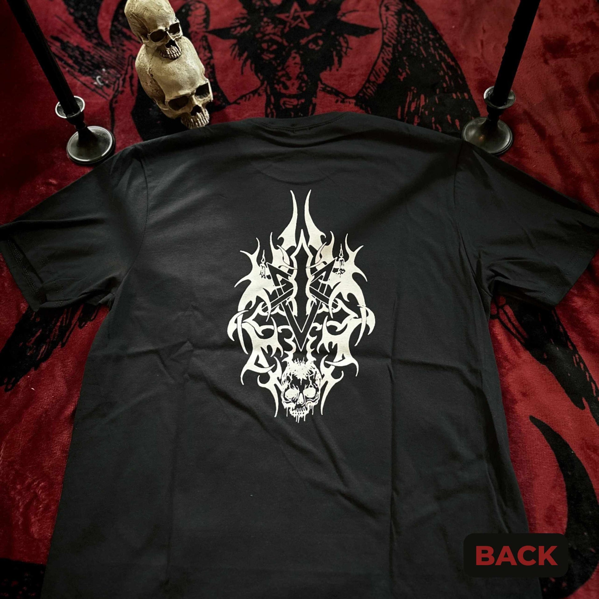 Black t-shirt with white tribal design on a red and black patterned background