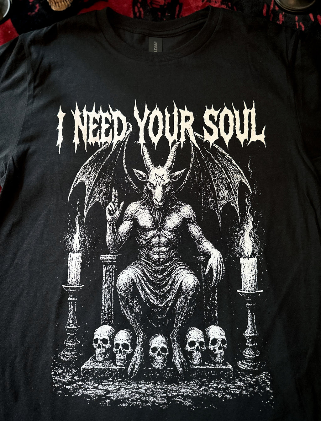Black t-shirt with a graphic design featuring a satanic figure and text 'I Need Your Soul' on a dark background.