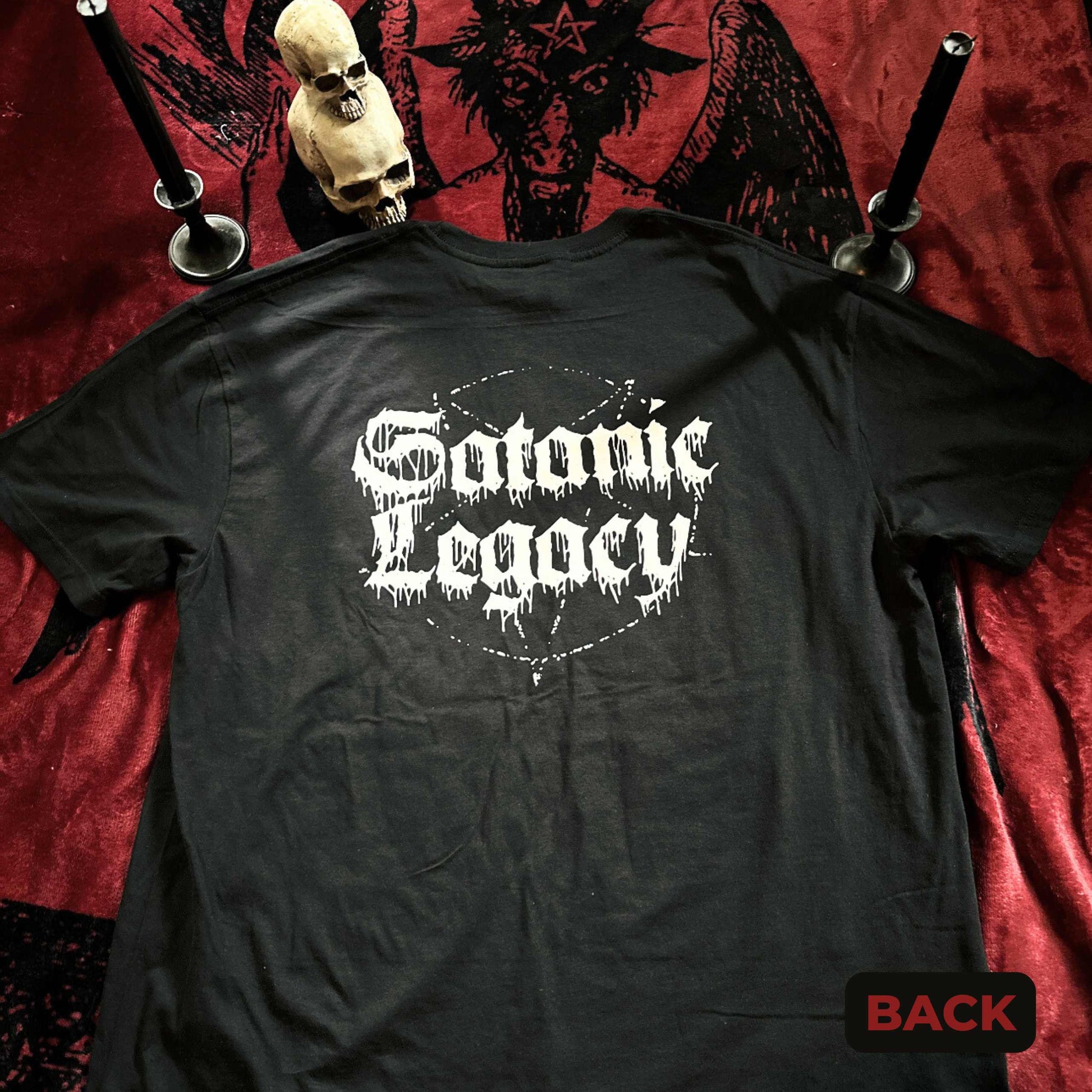 Black t-shirt with 'Satanic Legacy' text on a red fabric background